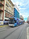 Oslo tram line 18 with low-floor articulated tram 157 on Grensen (2021)