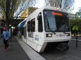Portland regional line Red with low-floor articulated tram 311 at Skidmore Fountain (2016)