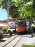 Sóller tram line with railcar 21 in front of Strandcafe I Soller, Carrer de la Marina (2013)