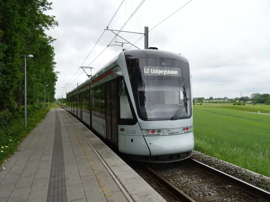 Aarhus light rail line L2 with low-floor articulated tram 1110-1210 at Nørrevænget  seen towards Aarhus (2021)
