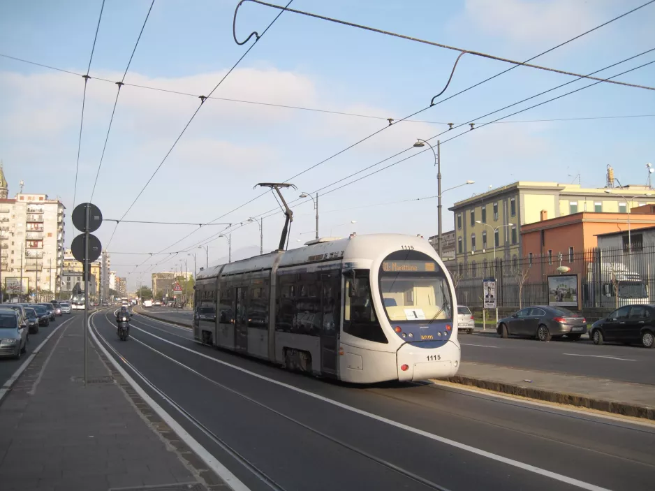 Naples tram line 1 with low-floor articulated tram 1115 on Via Amerigo Vecpucci, seen from behind (2014)