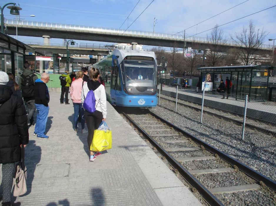 Stockholm tram line 30 Tvärbanan with low-floor articulated tram 413 at Årstaberg (2019)
