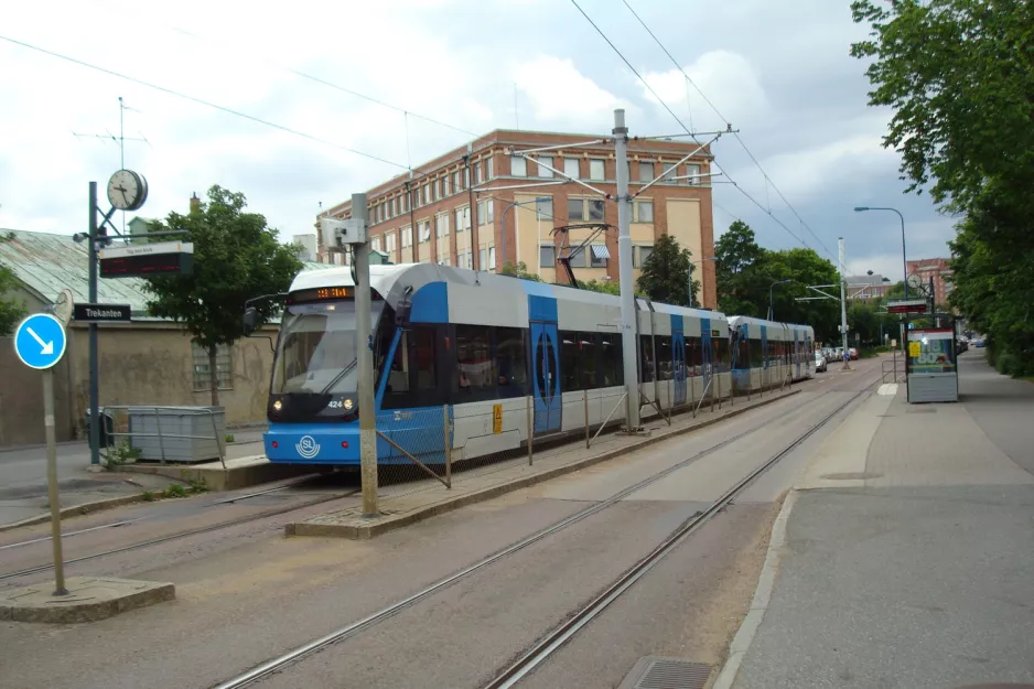 Stockholm tram line 30 Tvärbanan with low-floor articulated tram 424 at Trekanten (2012)