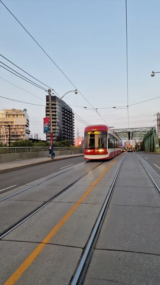 Toronto tram line 501 Queen with low-floor articulated tram 4410 near Queen St E at Carroll St (2024)