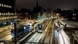 Trainspotting: Aarhus in Winter Skrud: The Light Rail Passes DOKK1 under Snow's Warm Cover ❄️🚊